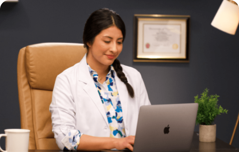 An eye doctor reviewing exam results for a contact lens prescription on their computer